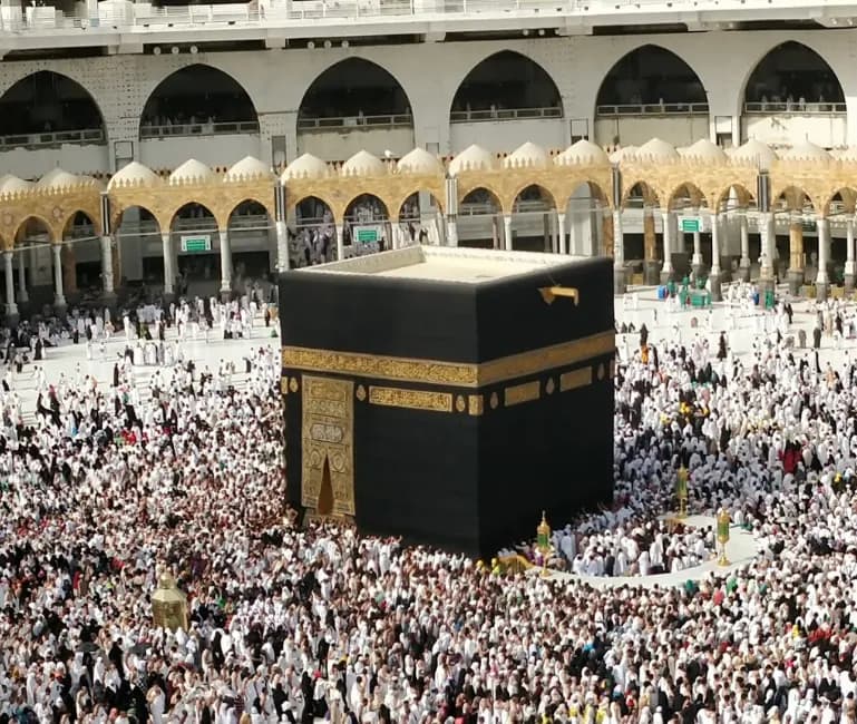 Pilgrims in white ihram around the Kaaba at Masjid al-Haram, Makkah