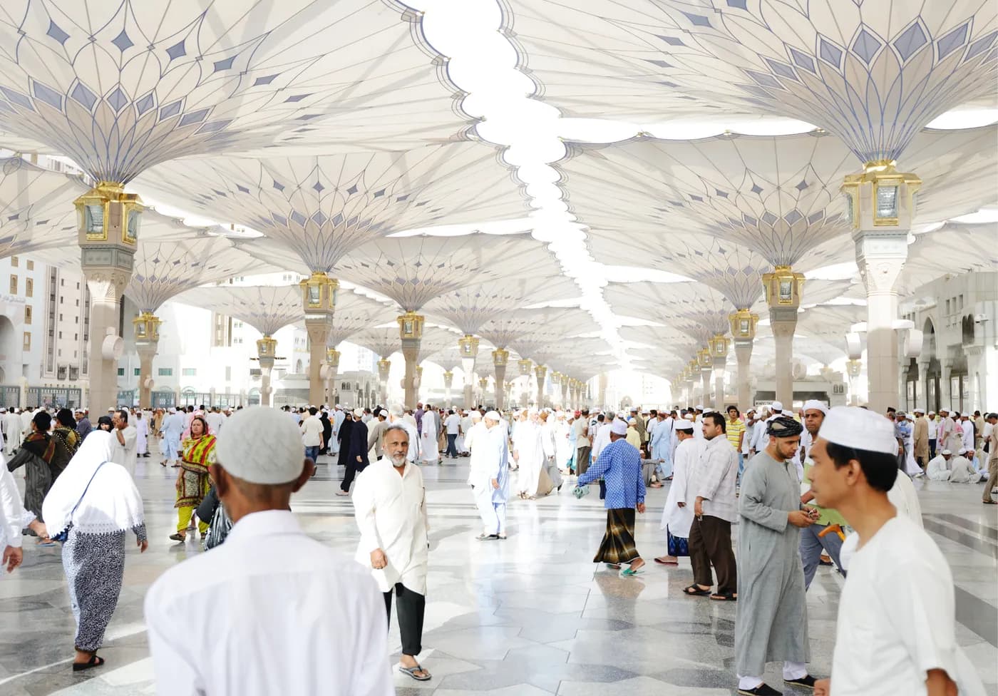 Pilgrims walking through the courtyard of Masjid an-Nabawi in Madinah