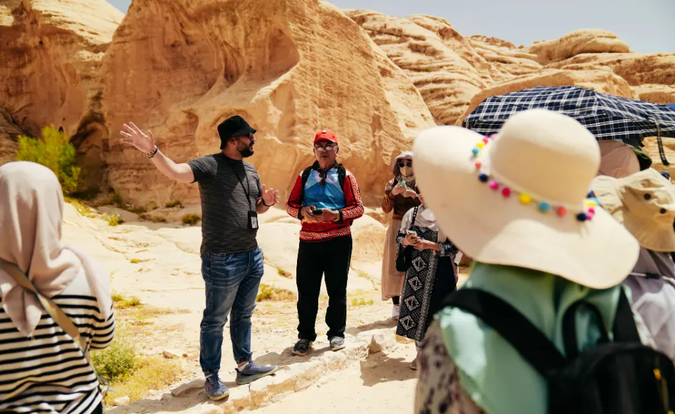 A guide leading travellers through a canyon