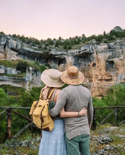 Travellers looking out over a green valley